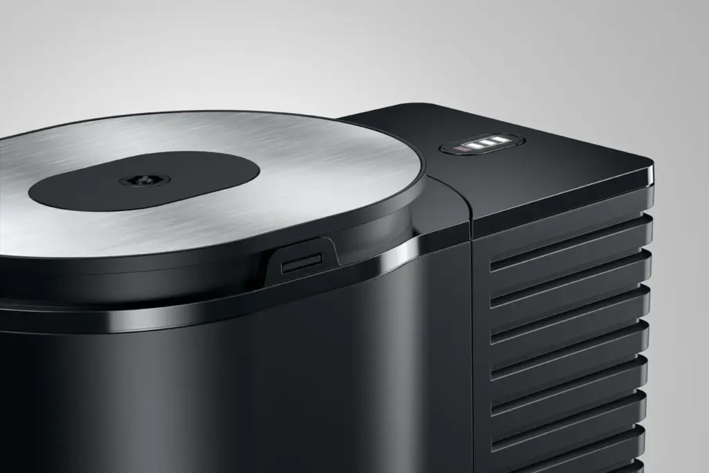 מקרר חלב JURA Cool Control שחור בנפח 1 ליטר, עם מכסה מתכת עגול ומחוון מפלס דיגיטלי בחלקו העליון. | אספרסימו